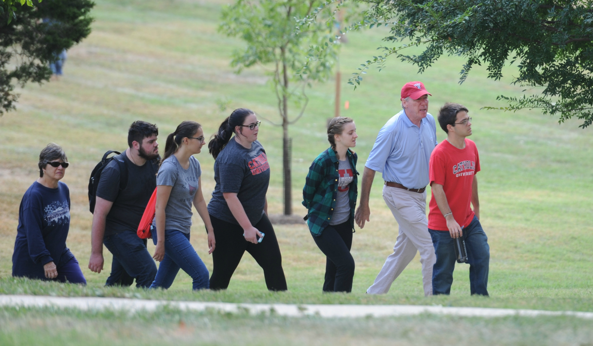 President Garvey and students walking through campus